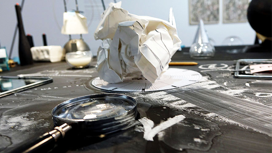 Nikolaus Gansterer, Transpositionsmodell II (Thinking<>Feeling<>Drawing<>Knowing), 2015, table, drawings, objects, video loop; installation view at the exhibition: Drawing Now, Albertina Museum, Vienna, Austria.