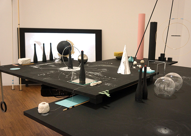 Nikolaus Gansterer, Transpositionsmodell II (Thinking<>Feeling<>Drawing<>Knowing), 2015, table, drawings, objects, video loop; installation view at the exhibition: Drawing Now, Albertina Museum, Vienna, Austria.